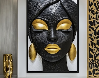 May include: A large, framed wall art piece featuring a sculpted face with closed eyes, gold lips, and gold earrings. The face is black with gold accents, set against a white background. The artwork is a striking decorative element.