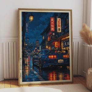 May include: A framed art print depicting a blue sports car parked on a wet city street at night. The scene features illuminated Japanese signage, a tall street lamp, and reflections on the pavement. The text includes JDM, Osaka, and Japanese characters.