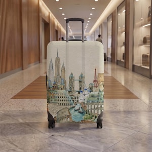May include: A rolling suitcase featuring a detailed, multi-coloured illustration of various global landmarks, including the Chrysler Building, Tower Bridge, the Colosseum, and Venetian canals, set against a light, off-white background.