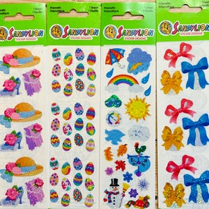 May include: Four sheets of colorful, glittery stickers with various themes. The first sheet features a hat, shoes, and a scarf. The second sheet features Easter eggs. The third sheet features weather-related images, including a rainbow, sun, clouds, and a snowman. The fourth sheet features bows in various colors.