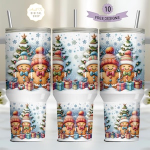 May include: A white stainless steel tumbler with a handle features a Christmas-themed design with gingerbread people and a Christmas tree. The tumbler has a straw and the text "10 FREE DESIGNS" is visible.