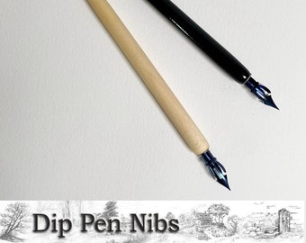 May include: Two dip pen nibs, one with a black wooden handle and one with a natural wood handle. Both nibs have a blue metal tip.