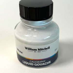 May include: A clear glass bottle of white calligraphy liquid gouache by William Mitchell. The bottle has a black cap and a label with the text "White" and "Calligraphy Liquid Gouache". The bottle contains 30ml of paint.