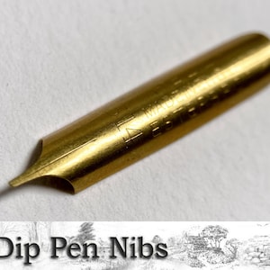 May include: A gold-colored dip pen nib with the text "MADE IN ENGLAND" engraved on the side.