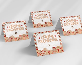 May include: Four white table cards with a gingerbread cookie theme. Each card has the text "Cookie Exchange" and a number from 1 to 4. The cards are decorated with gingerbread cookies, red bows, and white sprinkles.