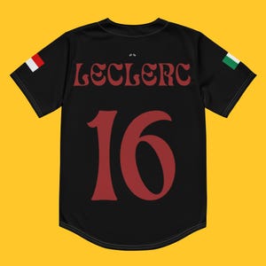 May include: Black jersey with red and white Italian flag on the left sleeve and a green and white flag on the right sleeve. The back of the jersey has the name "Leclerc" and the number "16" in red.