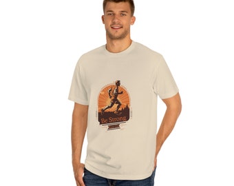 May include: Cream-colored t-shirt featuring a graphic of a runner silhouetted against a sunset. The design includes the text "Be Strong" and "Run On" in a brown, vintage style. The shirt is made of a soft, comfortable material.