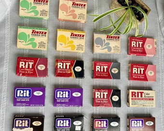 May include: A collection of 15 vintage dye boxes, including Rit and Tintez brands. The boxes are arranged in three rows of five. The boxes are all different colors and have different designs. Some of the boxes have the words "All Purpose" and "Concentrated Tint & Dye" on them. Some of the boxes have the words "Color Remover" and "For Washing Machine Use" on them.