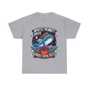 May include: A gray t-shirt with a graphic design of a blue whale in space. The whale is holding a pot of pink flowers. The text on the shirt reads "Infinitive Probability Drive" and "Absurdly Skipping in Space!"