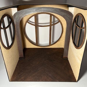 May include: A miniature room diorama with a brown wood floor, three arched windows, and a gray painted archway.
