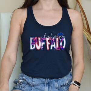 May include: A navy blue tank top with a white, red, and blue graphic that says "let's go BUFFALO".