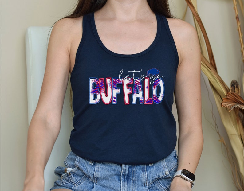 May include: A navy blue tank top with a white, red, and blue graphic that says "let's go BUFFALO".
