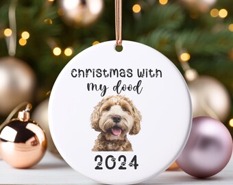 May include: White ceramic Christmas ornament with a brown and white doodle dog and the text "Christmas with my dood 2024".