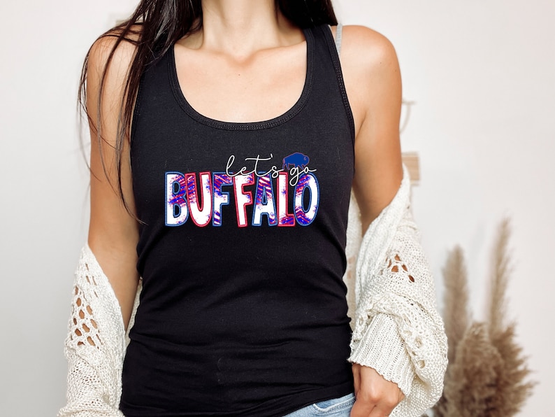 May include: Black tank top with a red, white, and blue graphic that says "Let's go Buffalo" with a buffalo silhouette.