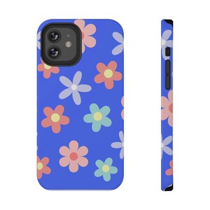 May include: A blue phone case featuring a pattern of colourful flowers. The case has a cut-out for the camera lens.