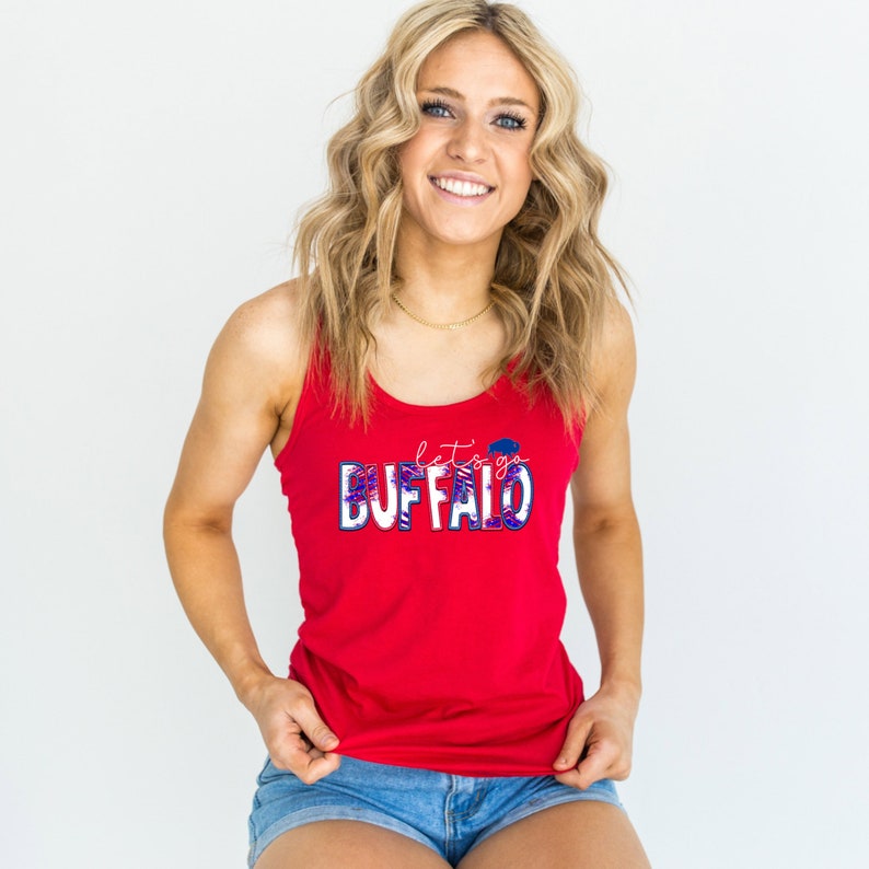 May include: Red tank top with a white and blue "Let's Go Buffalo" graphic. The graphic features a buffalo head and a red, white, and blue pattern.