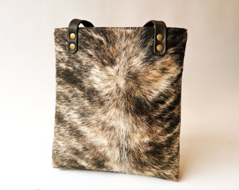 Cowhide and leather shoulder bag. Sustainably made, tough and unique