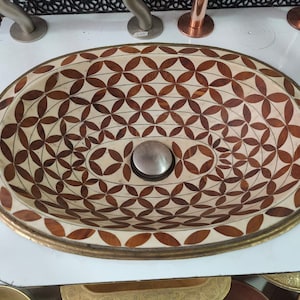 Solid unlacquered brass, bone, and a resin finish were used to create this luxurious Moroccan bathroom sink.