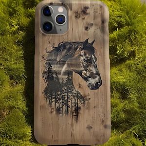 May include: A wooden phone case with a black and white image of a horse's head with a forest scene inside the horse's head.