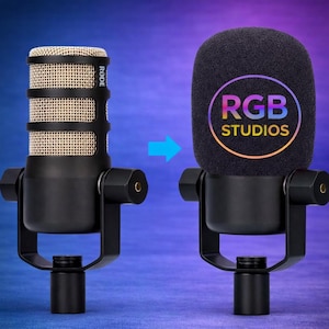 May include: A black microphone with a gold mesh head, shown with and without a black foam cover. The foam cover has the text "RGB STUDIOS" in a colorful gradient. The microphone is mounted on a black stand.