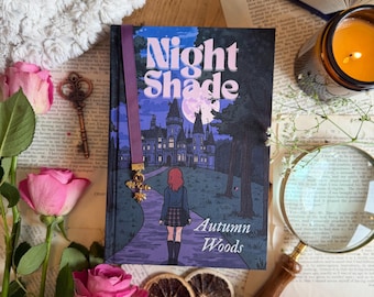 May include: A book titled "Night Shade" with a purple bookmark and a gold charm, featuring an illustration of a girl walking towards a castle. Pink roses, a key, and a magnifying glass surround the book. The author's name is "Autumn Woods".
