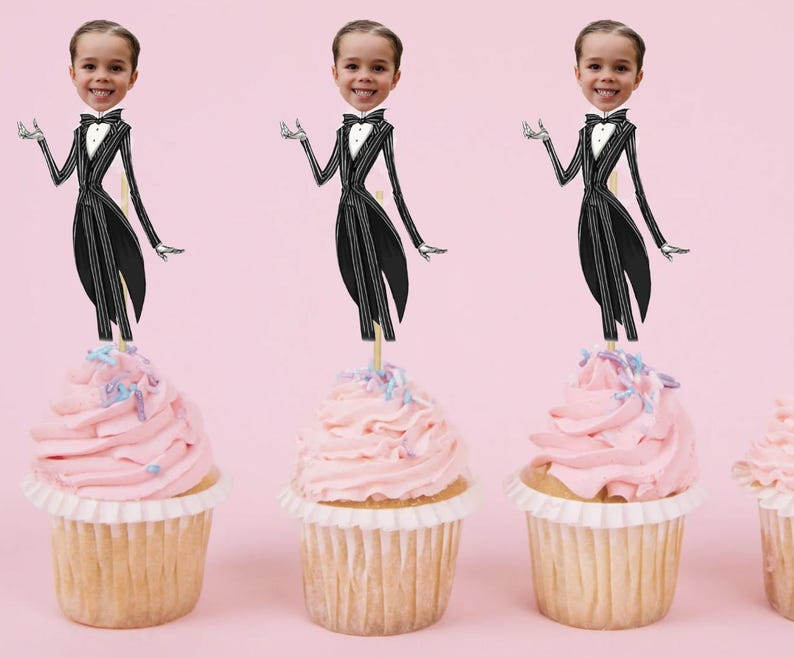 May include: Three cupcakes with pink frosting and colorful sprinkles topped with a black and white cartoon character wearing a tuxedo. The character's head is replaced with a photo of a person.