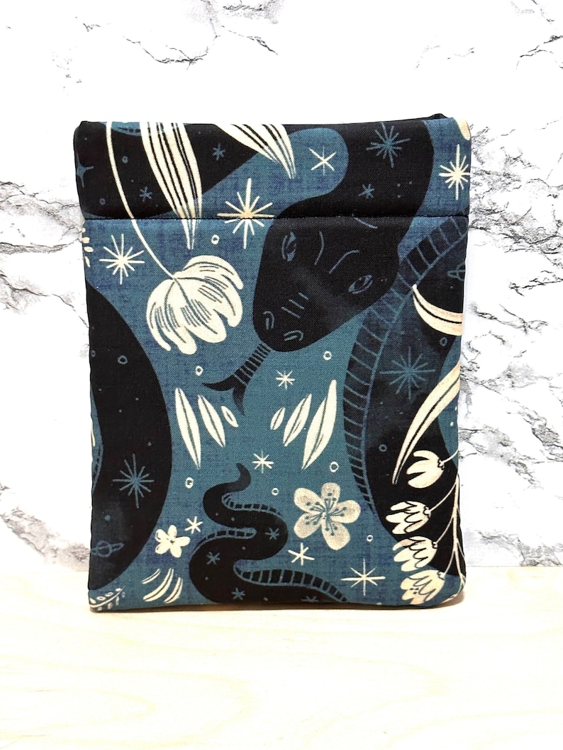 May include: A blue fabric pouch with a black snake and floral pattern. The pouch has a zipper closure and is ideal for carrying small items.