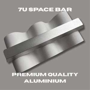 May include: A silver-colored 7U space bar made of premium quality aluminum. The space bar has a wavy design with a rectangular bar across the top. The text "7U SPACE BAR" and "PREMIUM QUALITY ALUMINIUM" are displayed in white.