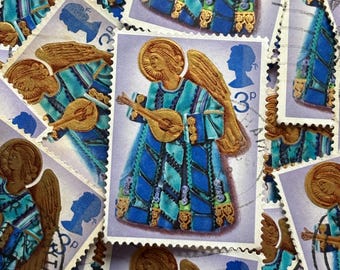 May include: A collection of vintage postage stamps featuring an angel playing a lute. The stamps have a blue, teal, and gold color scheme. The angel is depicted with a halo and wings. The stamps also feature a silhouette of a person and the number "3p".
