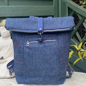 Made to order. Harris Tweed Fold-over Backpack. Good size and roomy. Blue check & herringbone fabric. Smart/casual bag. Authenticity label.