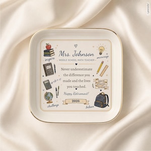 May include: A square white ceramic trinket dish with gold trim featuring illustrations of school supplies, a globe, and a backpack. Text reads: Mrs. Johnson, Middle School Math Teacher, Never underestimate the difference you made, Happy Retirement 2026.