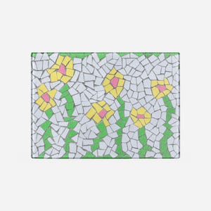 May include: A mosaic tile design featuring yellow flowers with pink centers on a white background with green leaves.