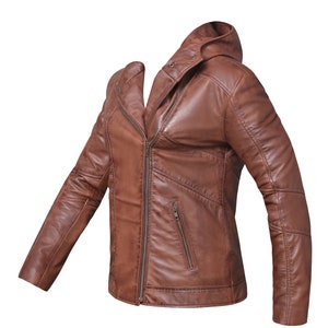 May include: A brown leather jacket with a zipper closure and a hood. The jacket has a zippered pocket on the left side and two zippered pockets on the right side.