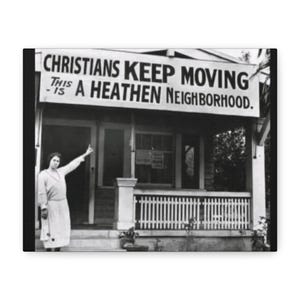 May include: A monochrome image shows a banner stating "CHRISTIANS KEEP MOVING - THIS IS A HEATHEN NEIGHBORHOOD." A woman in a dress gestures towards the sign. The sign is above a porch with a white picket fence.