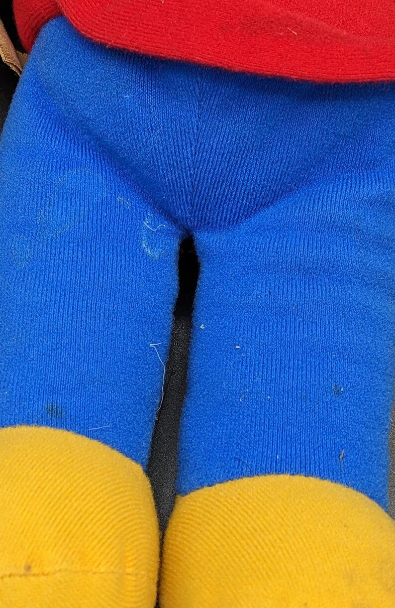 A close-up view of a pair of blue and yellow pants, with a red top visible.
