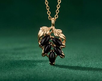 Colgante vintage de ónix negro y cristal Swarovski chapado en oro de 18 quilates, firmado por el diseñador.
