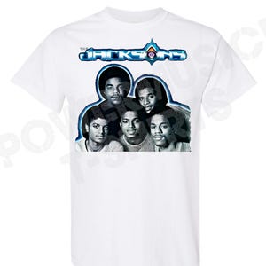 May include: White t-shirt with a black and white photo of The Jacksons band members. The band's name is printed in blue and white above the photo.