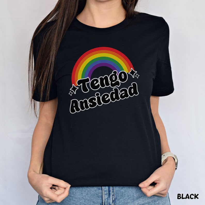 May include: Black t-shirt with a rainbow graphic and the text "Tengo Ansiedad" in a retro font.