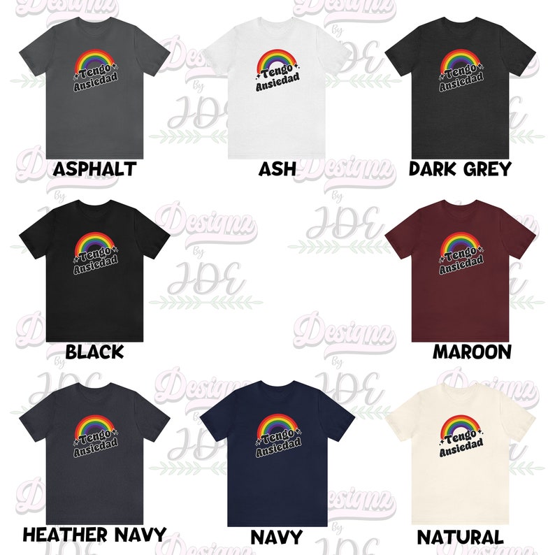 May include: A set of ten t-shirts in various colors featuring a rainbow graphic with the text "Tengo Ansiedad" in black. The colors include asphalt, ash, dark grey, black, maroon, heather navy, navy, and natural.