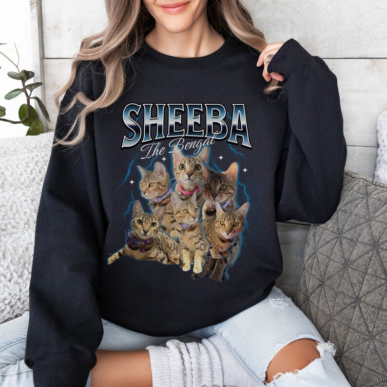 May include: Black sweatshirt with a graphic of a group of Bengal cats and the text "Sheeba The Bengal" in a blue and white retro font.