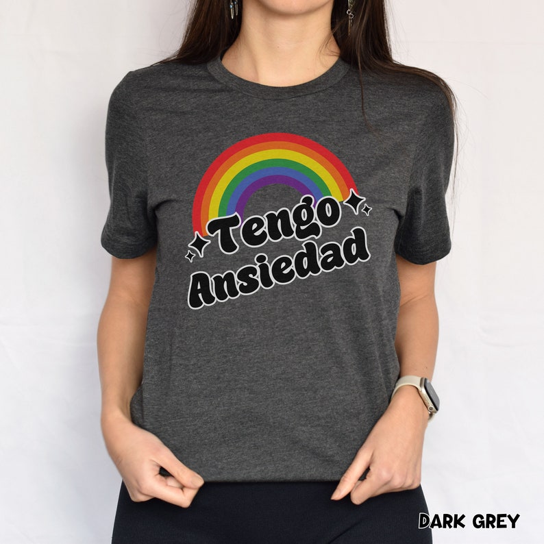 May include: A dark grey t-shirt with a rainbow and the text "Tengo Ansiedad" in black.