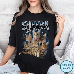 May include: Black t-shirt with a graphic of a group of Bengal cats. The text "Sheeba The Bengal" is above the cats.