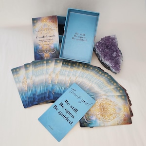 Oracle cards from Nature & Intuition deck displayed alongside crystals and geode on natural surface