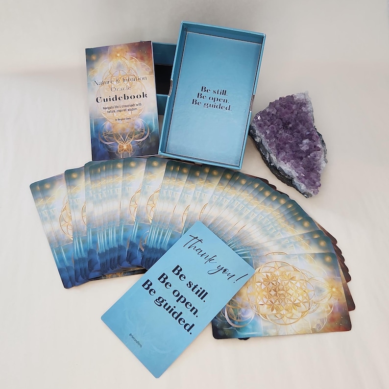 Oracle cards from Nature & Intuition deck displayed alongside crystals and geode on natural surface