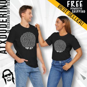 May include: Two black t-shirts with a white circle design featuring the text "RIP ATX". The shirts are being modeled by two people.