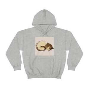 May include: A gray hooded sweatshirt with a graphic of a brown and white cat sleeping with the text "All the sweetness in her"