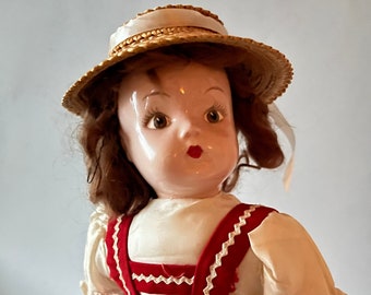 Porcelain doll in Red Dirndl Dress and Straw Hat from 1940s