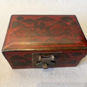 Antique Asian Red lacquerware wooden box with landscapes and figurative decorations.