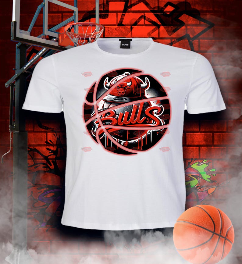 May include: White t-shirt featuring a red and black basketball graphic with the word "Bulls" and a bull's head wearing a hat.