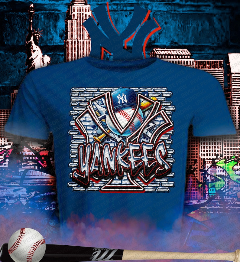 May include: Blue t-shirt featuring a baseball design with the text "Yankees" in a graffiti style. The design includes a baseball, a baseball cap, and the team's logo. A baseball and bat are in the foreground.